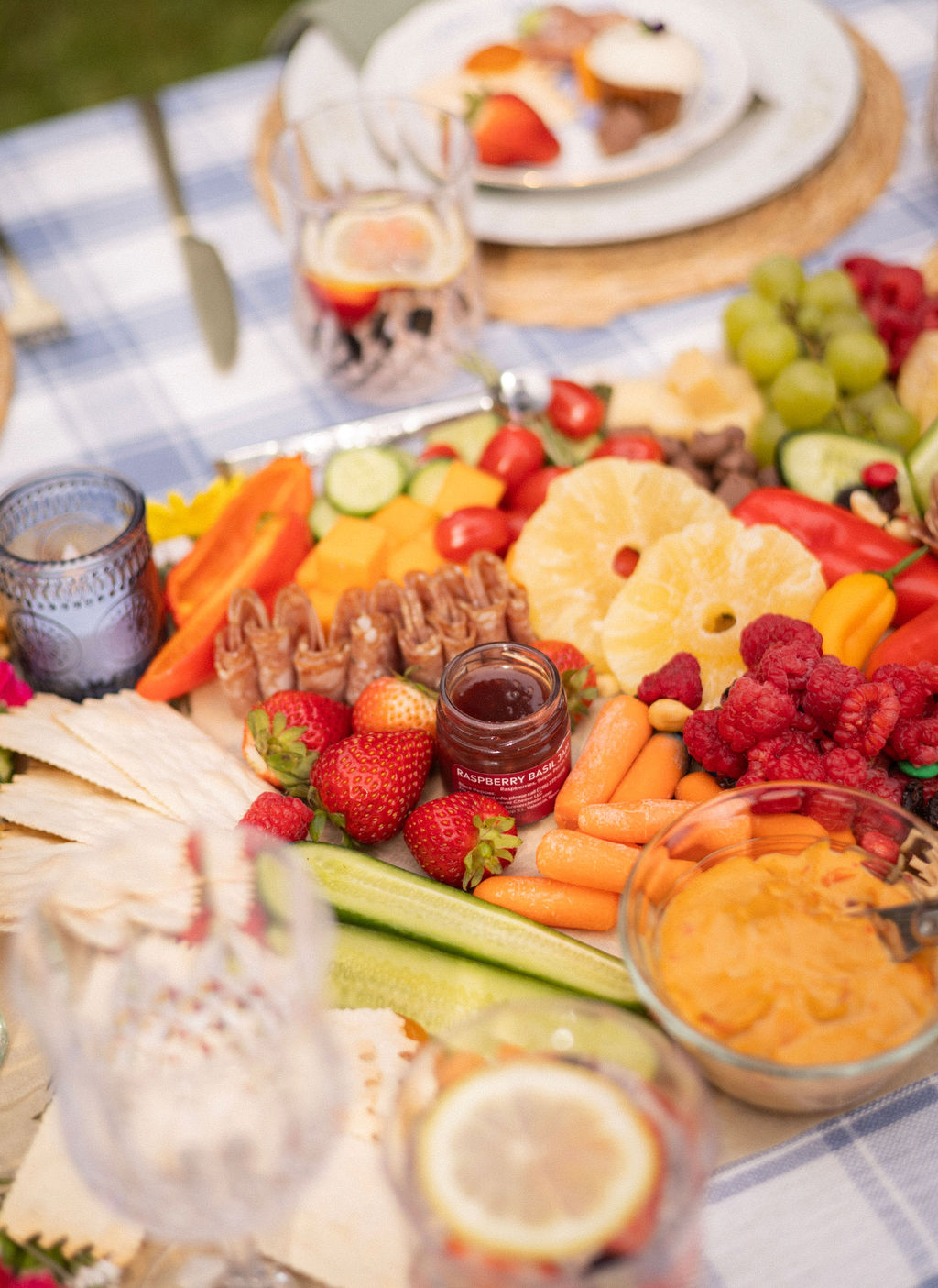Close up of a grazing spread with strawberries, pineapple, raspberries, prosciutto and dips